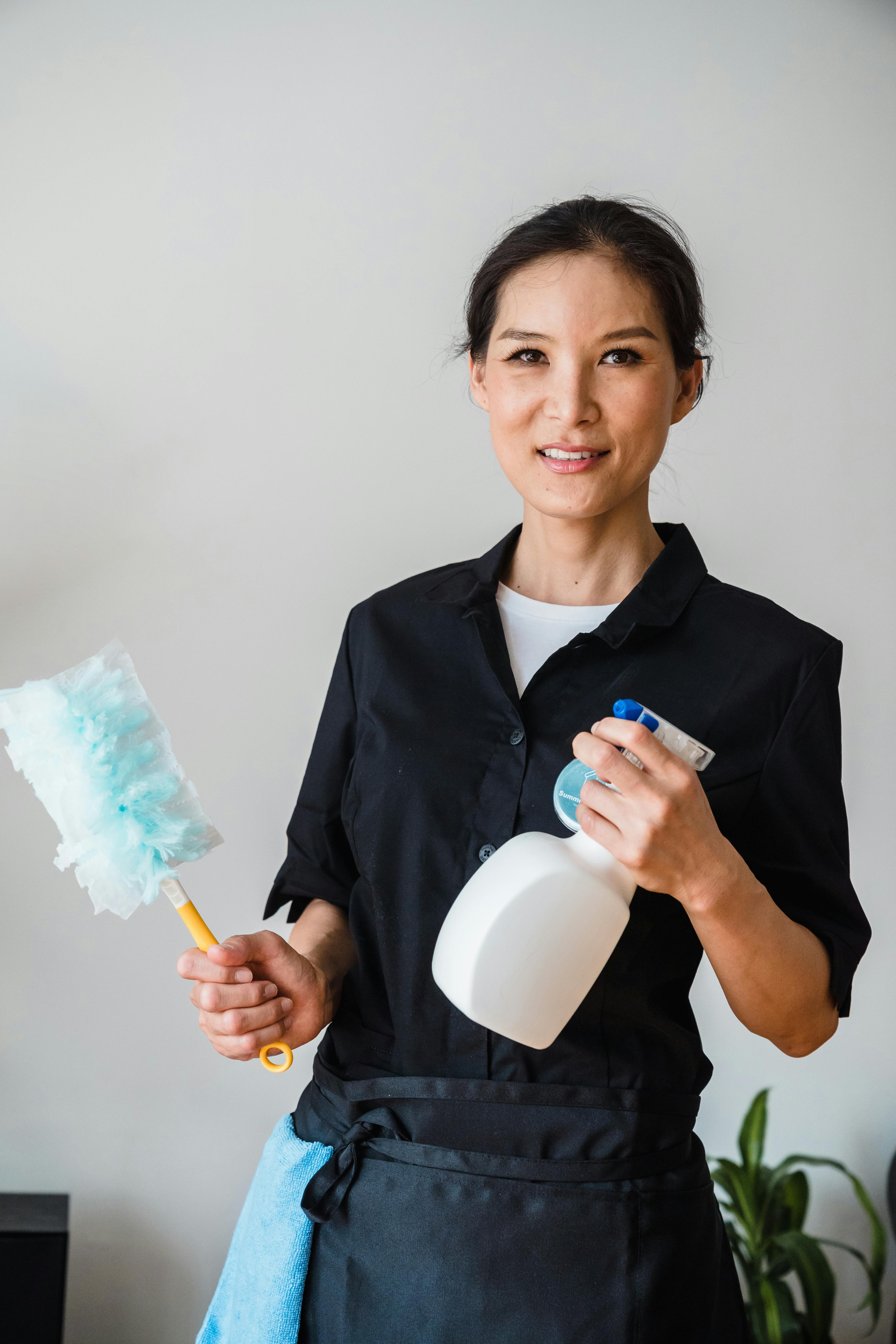 Professional cleaner with cleaning supplies